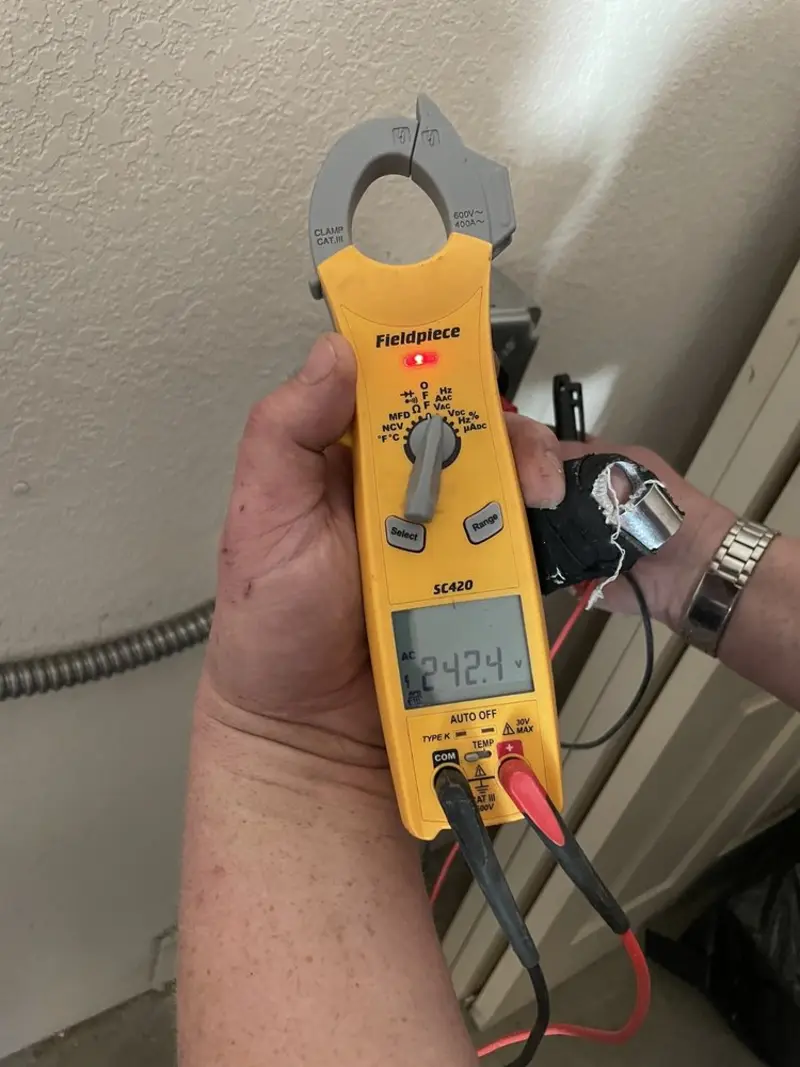 Voltage testing with clamp meter during Outlet Installation in Central Falls